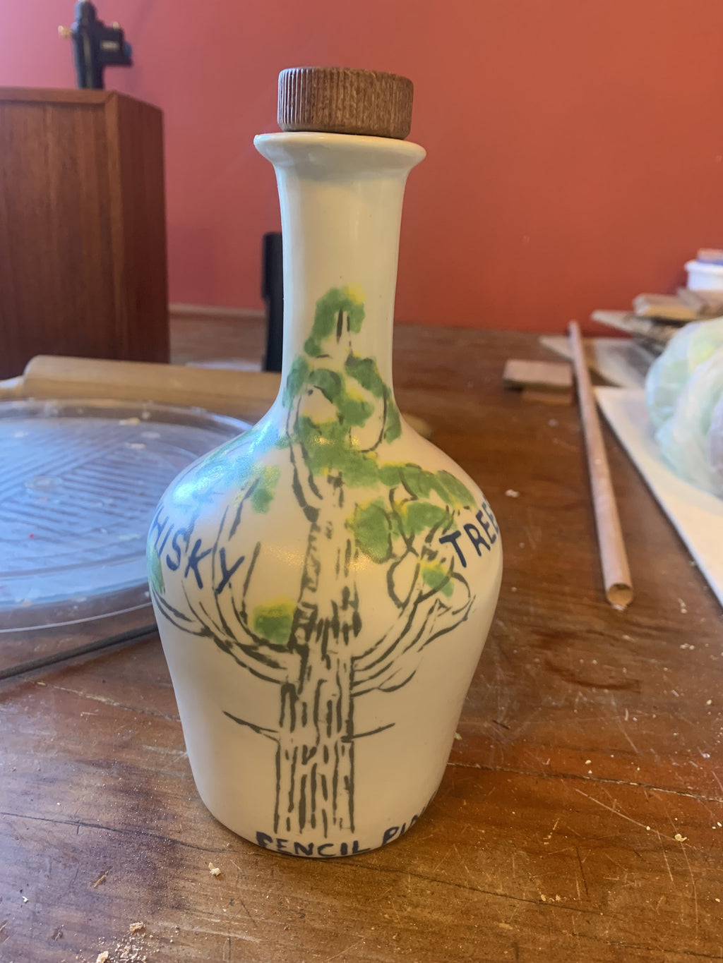 The Pencil Pine ceramic decanter with a hand-painted Athrotaxis cupressoides and timber stopper, in the St Helens studio