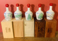 Five hand-painted Trees & Rain ceramic whisky decanters — Huon Pine, King Billy, Sassafras, Blackwood and Fagus — each on its branded 1838 Spirits timber box